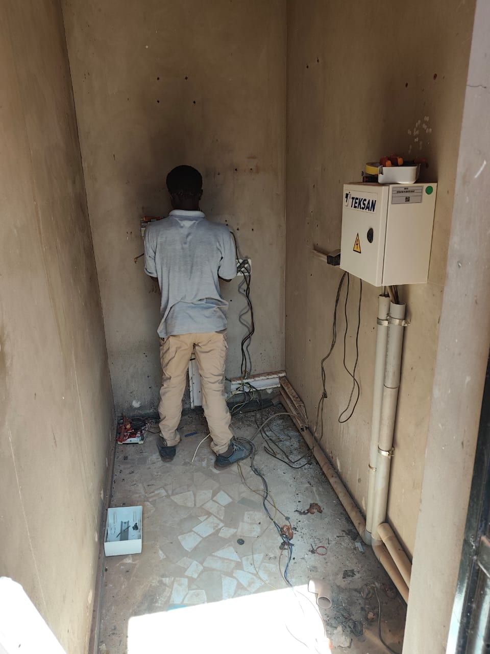 Technicians begin installing three SRNE 6 kVA hybrid inverters during the Burkina Faso proje